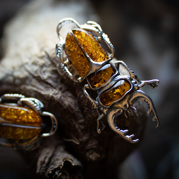 Silver store beetle pendant with amber